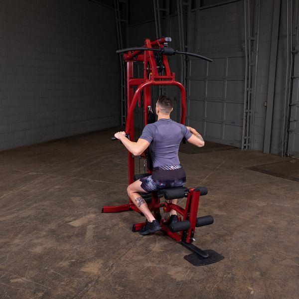 White male athlete performing seated rows on the Best Fitness by Body-Solid Single Stack Home Gym BFMG30."