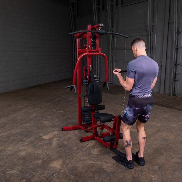 White male athlete performing standing bicep curl with low row short straight handle cable attachment on the Best Fitness by Body-Solid Single Stack Home Gym BFMG30.