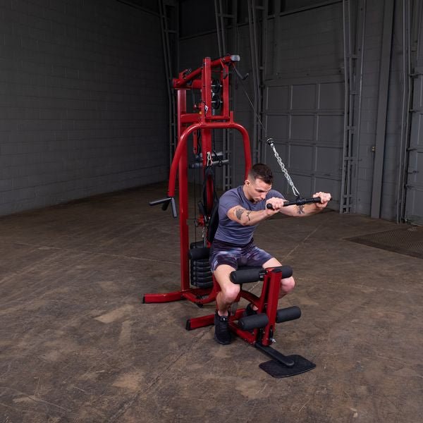 White male athlete performing seated overhead tricep extension on the Best Fitness by Body-Solid Single Stack Home Gym BFMG30.