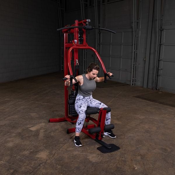 Female athlete performing a slightly bent forward chest press on the Best Fitness by Body-Solid Single Stack Home Gym BFMG30.
