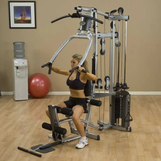 Female athlete performing a chest press with multi-grip press arms on the Powerline by Body-Solid P2X Multi-Functional Home Gym.