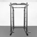 Front view of the BodyKore G703 Foundation Series Squat Cage featuring a multi-grip pull-up bar, J hooks, spotter bars, dual landmines, band pegs, and weight storage pegs, built with durable 3"x3" steel tubing for home or commercial gym use.