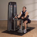 Athlete performing a bicep curl on the Body-Solid Pro Dual Bicep/Tricep Machine DBTC-SF