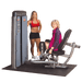Personal trainer assisting an older woman using the Body-Solid Pro Dual Inner/Outer Thigh Machine DIOT-SF