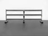 BodyKore G243 Dumbbell Rack in silver finish, angled from the front, set on black rubber gym flooring, highlighting its sleek design and durable build.