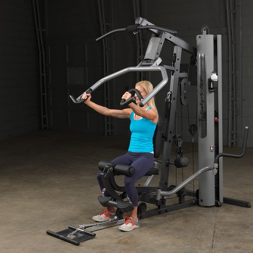 Female athlete completing chest press on Body-Solid G5S Home Gym, arms fully extended forward.