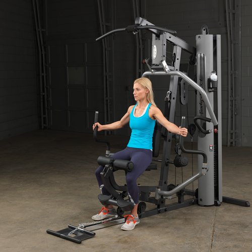 Female athlete performing chest fly on Body-Solid G5S Home Gym with arms extended outward