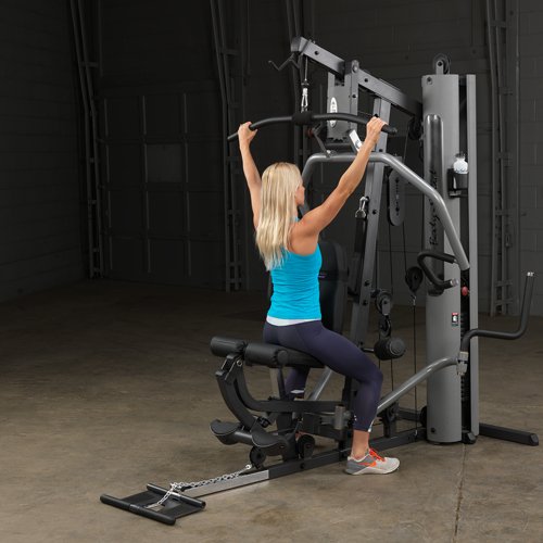 Female athlete performing a lat pulldown on Body-Solid G5S Home Gym with an overhand grip."