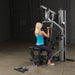 Female athlete performing a lat pulldown on Body-Solid G5S Home Gym with an underhand grip