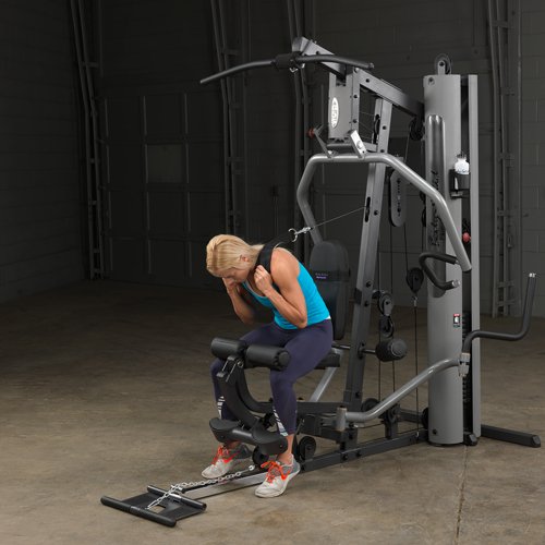 Female athlete doing an ab crunch on Body-Solid G5S Home Gym, pulling cable down from overhead.