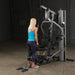 Female athlete performing a tricep pushdown on Body-Solid G5S Home Gym, arms fully extended downward