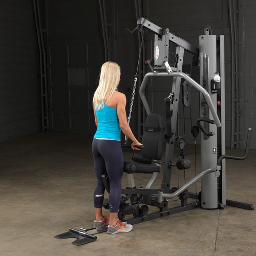 Female athlete nearly completing a tricep pushdown on Body-Solid G5S Home Gym