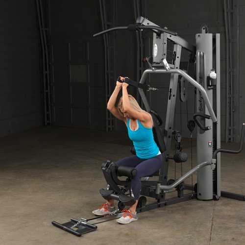 Female athlete performing tricep extension on Body-Solid G5S Home Gym using mid cable attachment