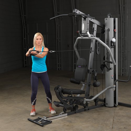 Female athlete executing lateral twist on Body-Solid G5S Home Gym using mid cable attachment.