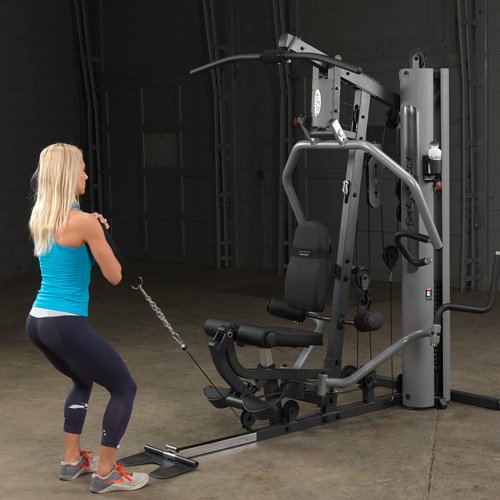 Female athlete performing squats on Body-Solid G5S Home Gym using cable resistance.