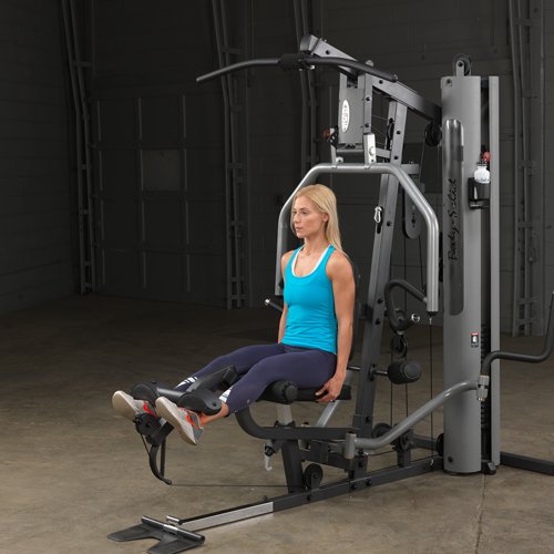 Female athlete doing seated leg extension on Body-Solid G5S Home Gym, extending legs forward