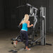 Female athlete performing single leg standing curl on Body-Solid G5S Home Gym with low cable attachment.