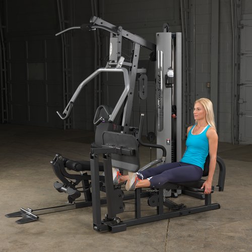 Female athlete using optional leg press attachment for calf extensions on Body-Solid G5S Home Gym.