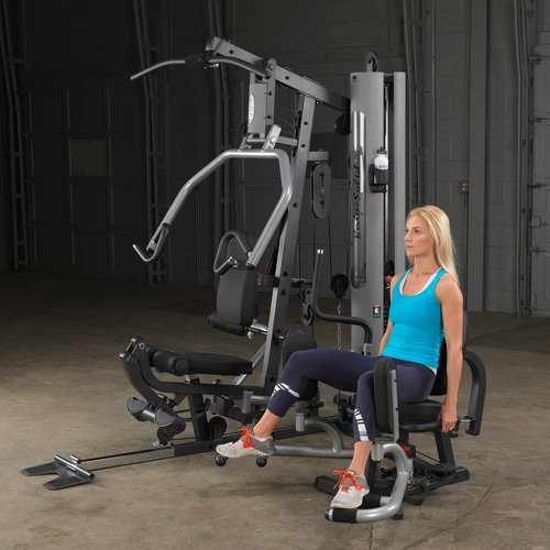 Female athlete performing hip abduction exercise using optional hip abductor attachment on Body-Solid G5S Home Gym