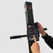 Close-up of a user operating the tablet with their finger on the VersaClimber H-TS model, focusing on the interaction with the touchscreen display for selecting workout programs and fitness classes.
