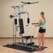 White female athlete in a teal top performing standing bicep curl from the low row cable on Powerline Home Gym PHG1000X.