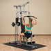 White female athlete in a teal top performing lat pulldown on the Powerline Home Gym PHG1000X.
