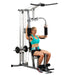White female athlete in a teal top performing pec deck exercise on Powerline Home Gym PHG1000X.