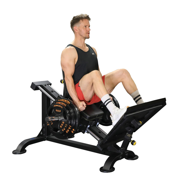 Side view of the Powertec Compact Leg Sled P-CLS23 with an athlete in the starting position, extending the leg press with weight plates loaded.
