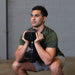 Person holding a Body-Solid Tools SDBX132 Adjustable Dumbbells performing a front squat.