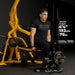 tall Athlete using the Powertec WB-LLA Leg Lift-Curl Attachment on a lever gym