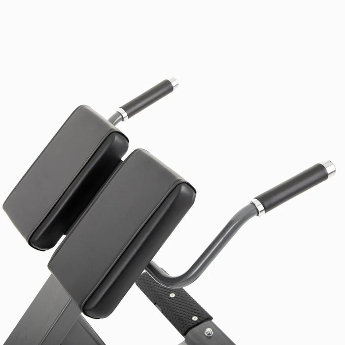 Close-up view of the padded thigh support and ergonomic handles on the Commercial Hyper Extension Bench 876HP