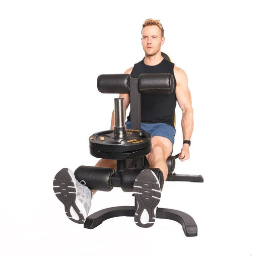 Athlete using the Powertec WB-LLA Leg Lift-Curl Attachment on a Workbench