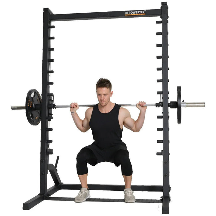 Athlete performing a squat with barbell and weights on the Powertec Roller Smith Machine WB-RS
