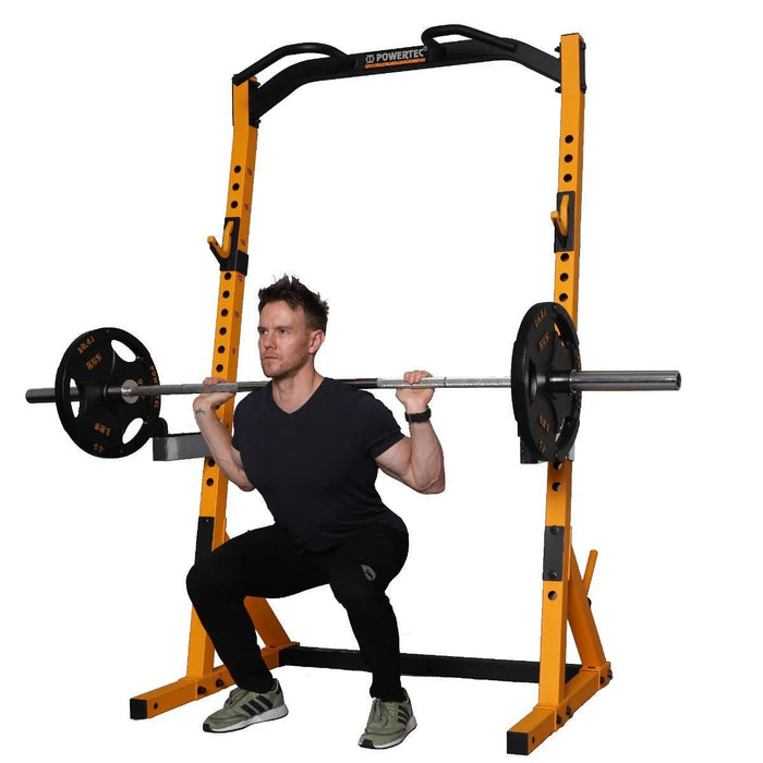 Athlete squatting with barbell and weight plates on the Workbench Half Rack WB-HR-Y with yellow frame