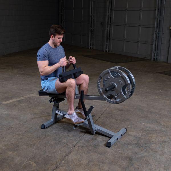 Male athlete working out on the Body-Solid GSCR349B Seated Calf Raise Machine with grey weight plates, demonstrating proper use and form.