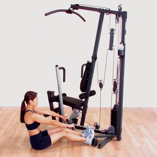 Female athlete performing seated rows on a Body-Solid G1S Multi-Station Home Gym, focusing on building back strength and improving posture.