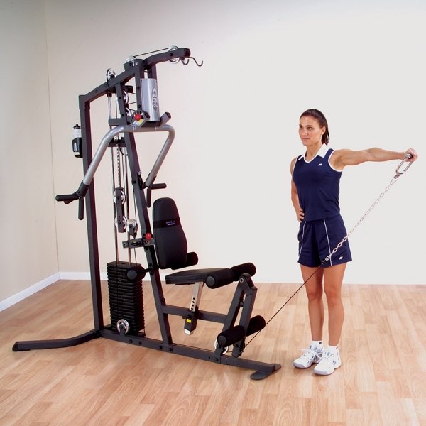 Woman performing a one-arm lateral side raise with a low row cable attachment in a standing position on the Body-Solid G3S