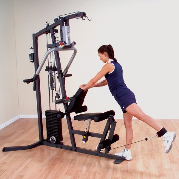 Woman performing a one-leg kick back with a low row cable attachment in a standing position on the Body-Solid G3S