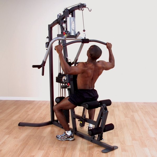 Black male athlete performing a lat pulldown on the Body Solid Home Gym G3S using the high pulley attachment.