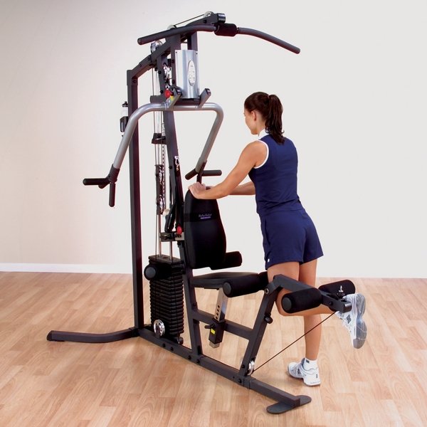 Woman performing a single leg kickback using the low pulley attachment on the Body Solid Home Gym G3S