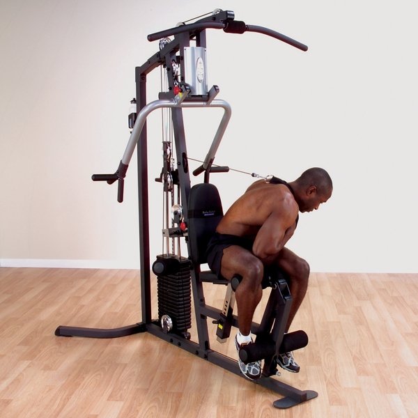 Person performing an ab crunch using the high pulley attachment on the Body Solid Home Gym G3S.